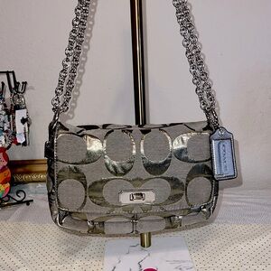 Coach Small canvas crossbody with oversized signature logo and hangtag.